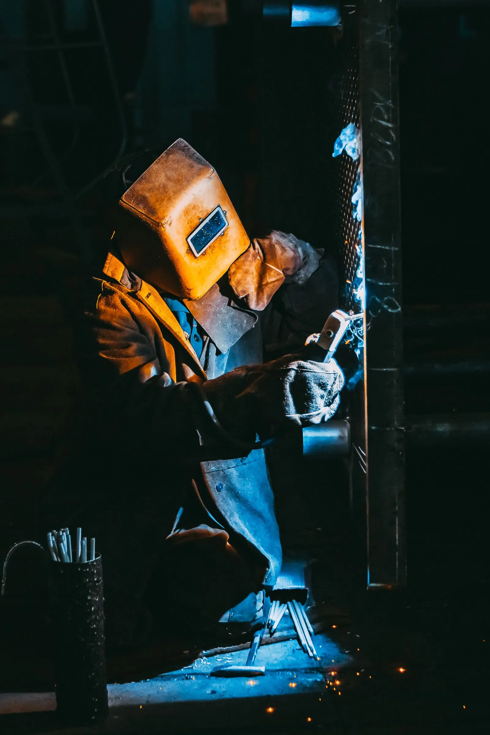 A DEPL welder in full protective gear working on a steel joint