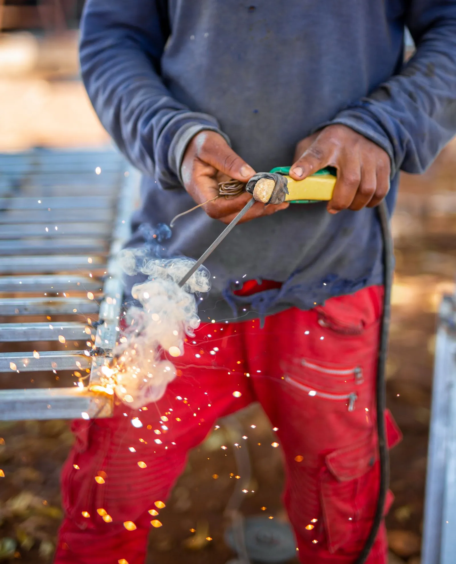 Welder joining steel with an electrode, sparks flying
